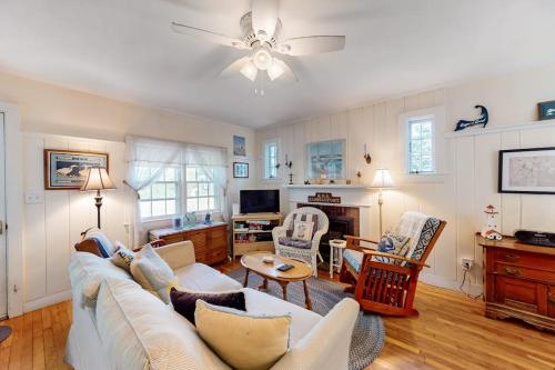 a living room with a white couch and chairs at The Spray in Harwich Port