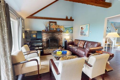 a living room with a couch and a fireplace at Bayview in Truro