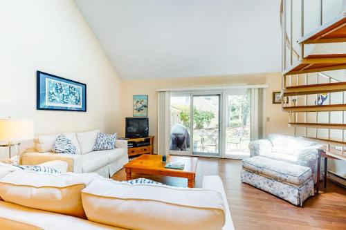a living room with two couches and a table at Relaxing Cape Getaway in Brewster