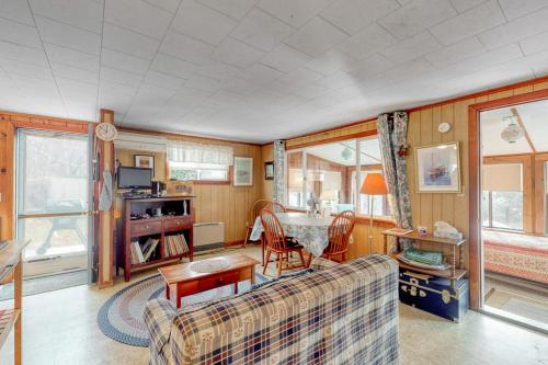 a living room with a couch and a table at Villa Fairview in South Dennis