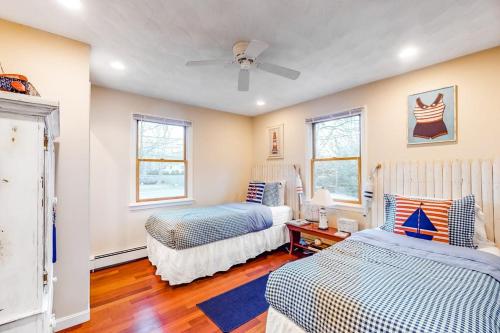 a bedroom with two beds and a ceiling fan at Brewster House in Oak Bluffs