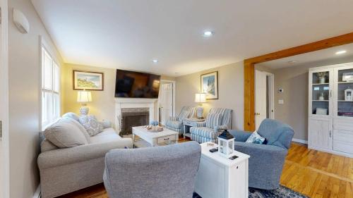 a living room with couches and chairs and a fireplace at Cape Cod Playhouse in Yarmouth