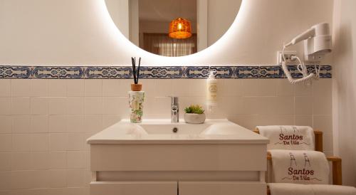 a bathroom with a white sink and a mirror at Santos da Vila in Sintra