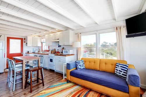 a living room with a couch and a kitchen at Dunes Edge in Wellfleet