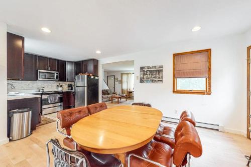 a kitchen with a wooden table and leather chairs at Lake Shore Living in Falmouth