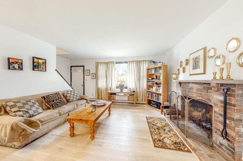 a living room with a couch and a fireplace at Lake Shore Living in Falmouth
