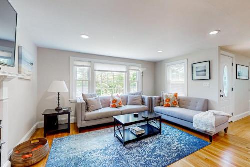 a living room with a couch and a table at Ocean Bird Nest in South Yarmouth