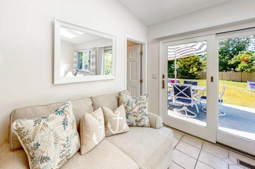 a living room with a couch and a patio at Sea You Later in West Yarmouth