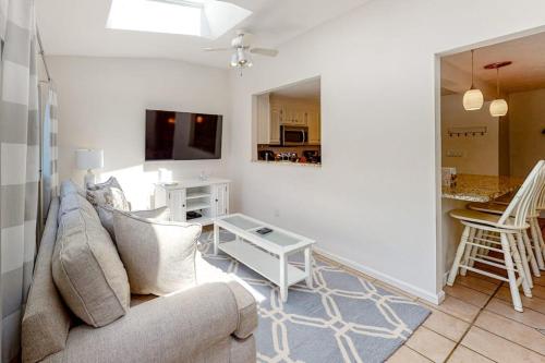 a living room with a couch and a table at Sea You Later in West Yarmouth