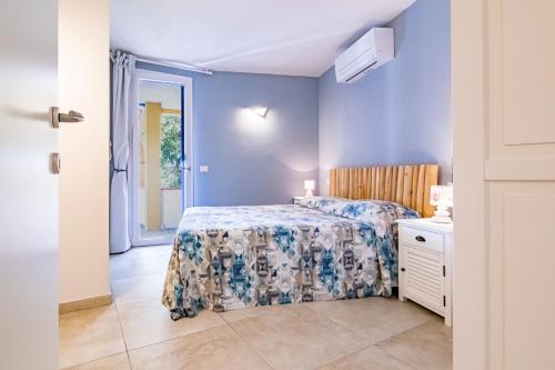 a bedroom with a bed in a room with a door at Tra il Borgo e il Mare - Bel Horizonte in Capoliveri
