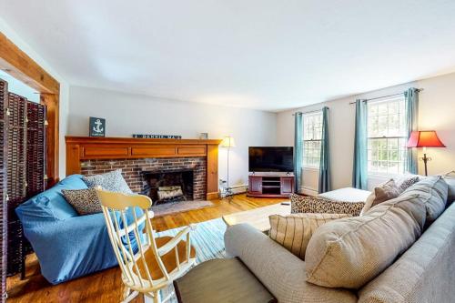a living room with a couch and a fireplace at Dream Dennis Getaway in Dennis