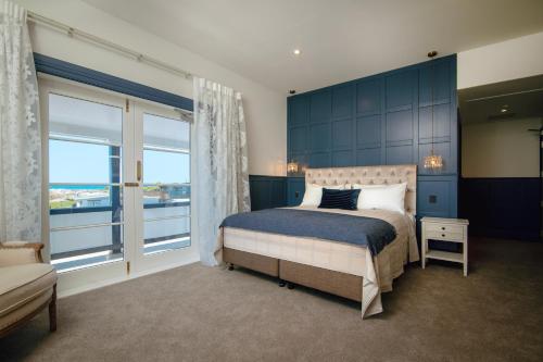a bedroom with a bed and a large window at The Pier Hotel in Kaikoura
