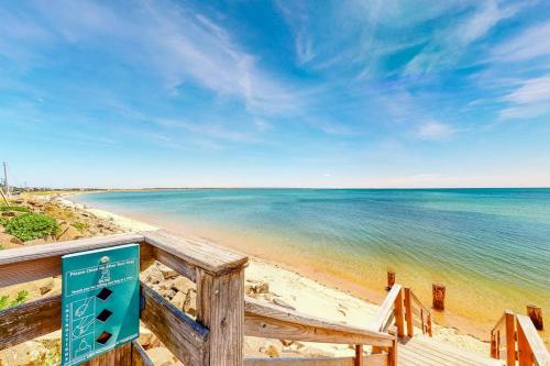 a beach with a sign next to the ocean at Bay Colony Vista in Provincetown