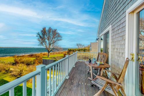a deck with a table and chairs on a house at Barnstable Harbor Home in Barnstable