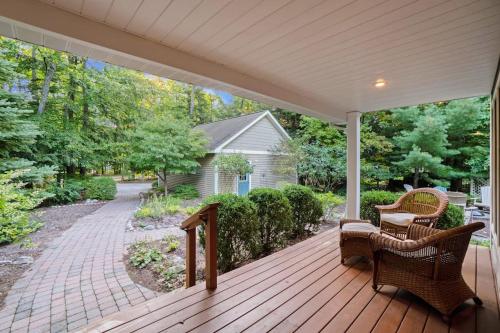 a porch with two wicker chairs and a porch at Between the Lakes in Glen Arbor