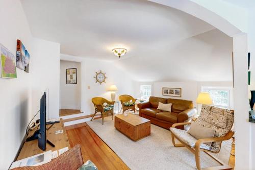 a living room with a couch and a tv at Everyday is Saturday in Vineyard Haven