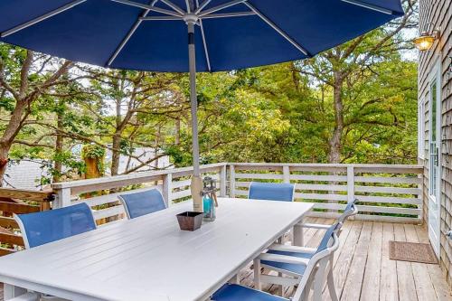 a table and chairs with an umbrella on a deck at Lake Elizabeth Terrace in Centerville