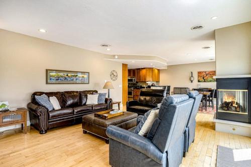 a living room with leather furniture and a fireplace at Lake View Getaway in Saugatuck