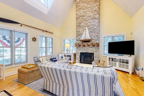 a living room with two couches and a fireplace at The Lighthouse in Lakeshore Cottages in Union Pier