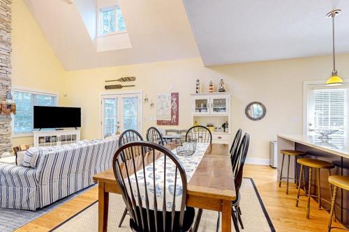 a dining room with a table and chairs and a couch at The Lighthouse in Lakeshore Cottages in Union Pier