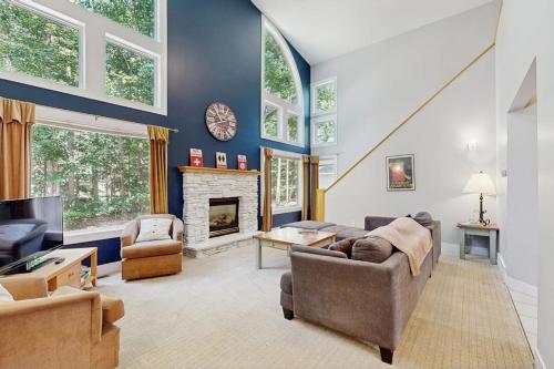 a living room with a couch and a fireplace at The Treehouse in Thompsonville