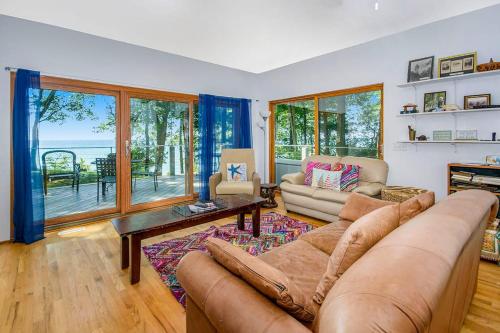 a living room with a couch and a table at Jacobia Lakefront Retreat in Covert