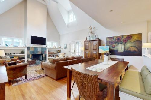 a living room with a table and a couch at Seaglass Lakeshore Cottage in Union Pier