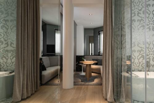 a living room with a couch and a tub in a room at Macalister Mansion, a Member of Design Hotels in George Town
