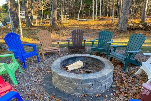 a group of colorful chairs around a fire pit at Serenity at Stormy Lake in Conover