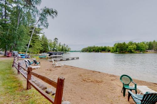 a group of benches on the shore of a lake at Loon Loft in Saint Germain