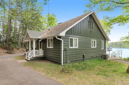 a small green house with a gambrel roof at Northwoods Oasis in Land O' Lakes
