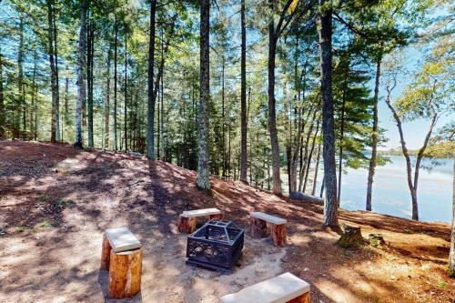 a group of benches sitting on a hill near the water at Chalet on the Bay in Saint Germain