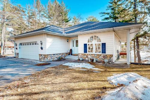 a white house with a blue roof at Yellow Birch Memories in Eagle River