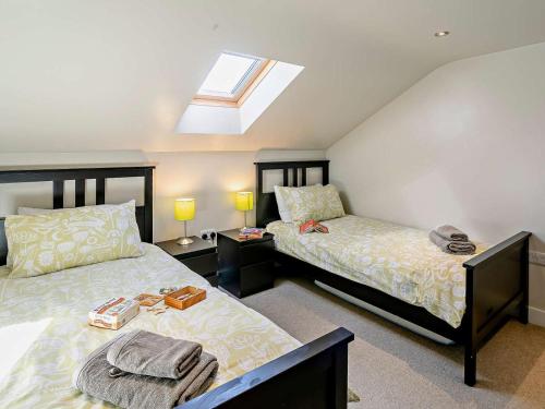 a bedroom with two beds and a skylight at 2 Bed in Holmfirth oc-emley in New Mills