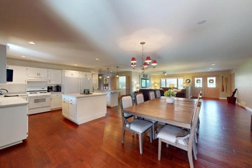 a kitchen and dining room with a wooden table and chairs at The 19th Hole Lakeside in Eagle River