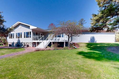 a large white house with a large yard at The 19th Hole Lakeside in Eagle River
