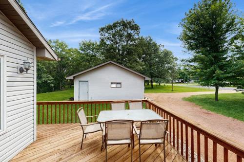 a patio with a table and chairs on a deck at Rome Retreat- Steps from Beach & Golf in Nekoosa