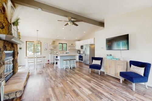 a large living room with a fireplace and a kitchen at Rome Retreat- Steps from Beach & Golf in Nekoosa