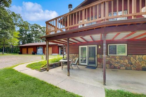 a house with a porch and a patio at Rustic Woodland Retreat- Unit A in Arkdale