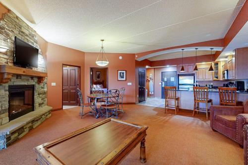 a living room with a table and a fireplace at Chula Vista Condo #2402 in Wisconsin Dells