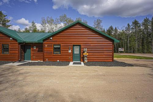 a log cabin with a green door in front of it at The Beaver in Conover