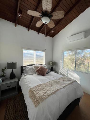 a bedroom with a bed and a ceiling fan at Casa Xantus in Toros Pintos