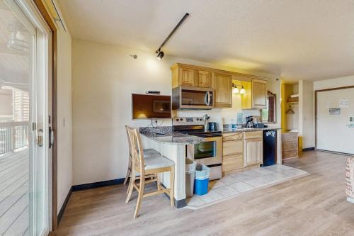 a kitchen with wooden cabinets and a table and chairs at Chula Vista Resort Villa # 7212 in Wisconsin Dells