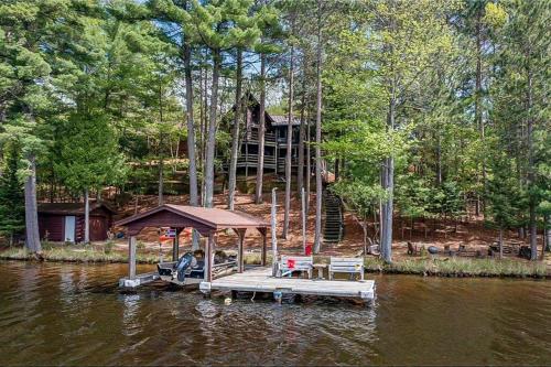 a house on a dock in the middle of a river at Sailor's Point Lodge in Eagle River