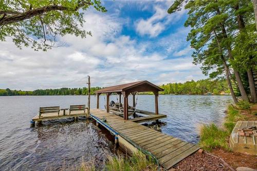 a wooden dock with a gazebo on a lake at Sailor's Point Lodge in Eagle River
