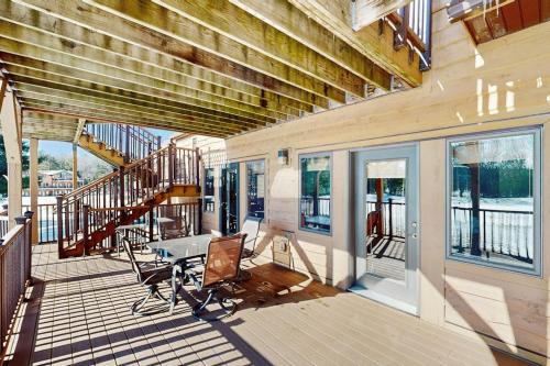 a porch with a desk and stairs on a house at Sunset Condominiums: Golf View in Arkdale