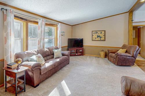 a living room with a couch and a television at Thoro Cottage in Minocqua