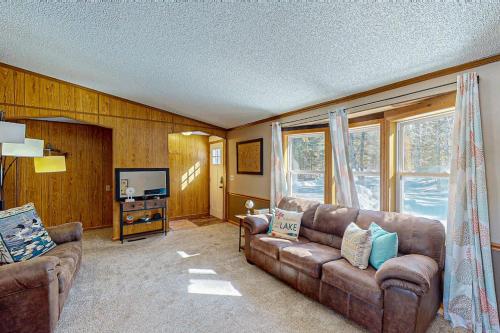 a living room with a couch and a television at Thoro Cottage in Minocqua