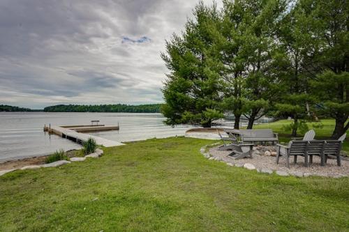a picnic table and bench next to a lake at Island View I in Eagle River