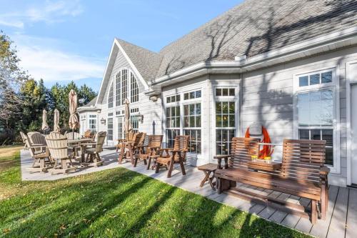 a house with a patio with chairs and a table at North Twin Lake House in Phelps